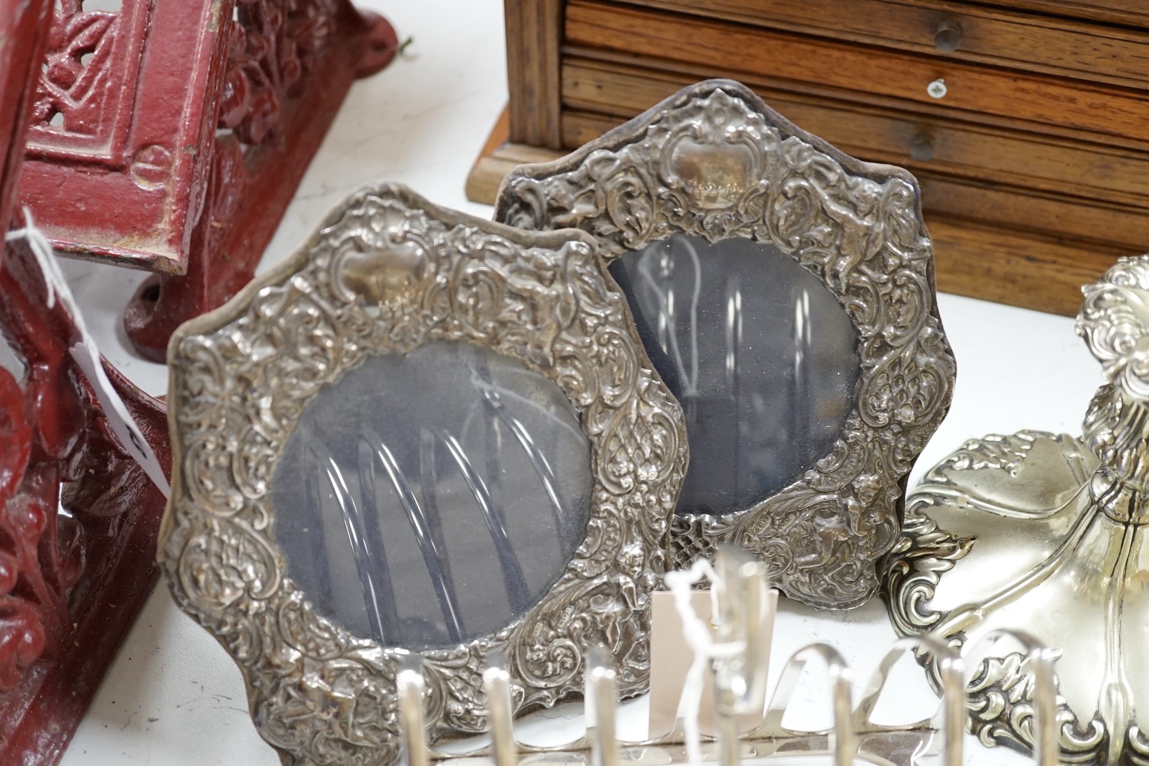 A pair of embossed silver photograph frames and plated wares